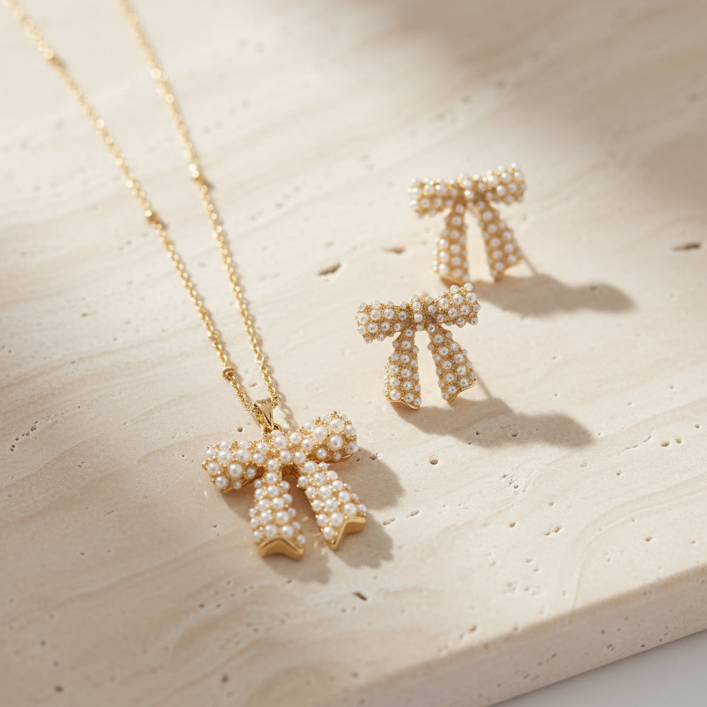 Gold bow-shaped earrings and necklace