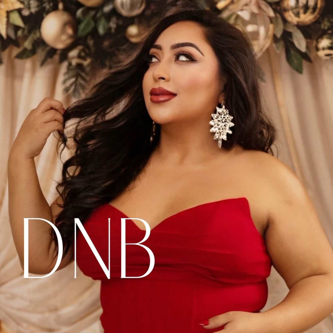 Woman in a red dress with floral background and 'DNB' branding