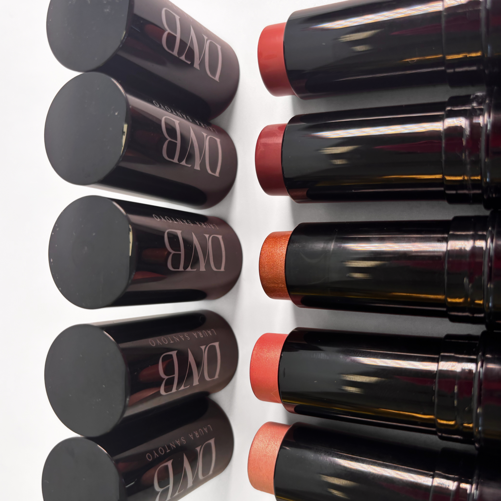 Set of lipsticks with visible brand name on a white background