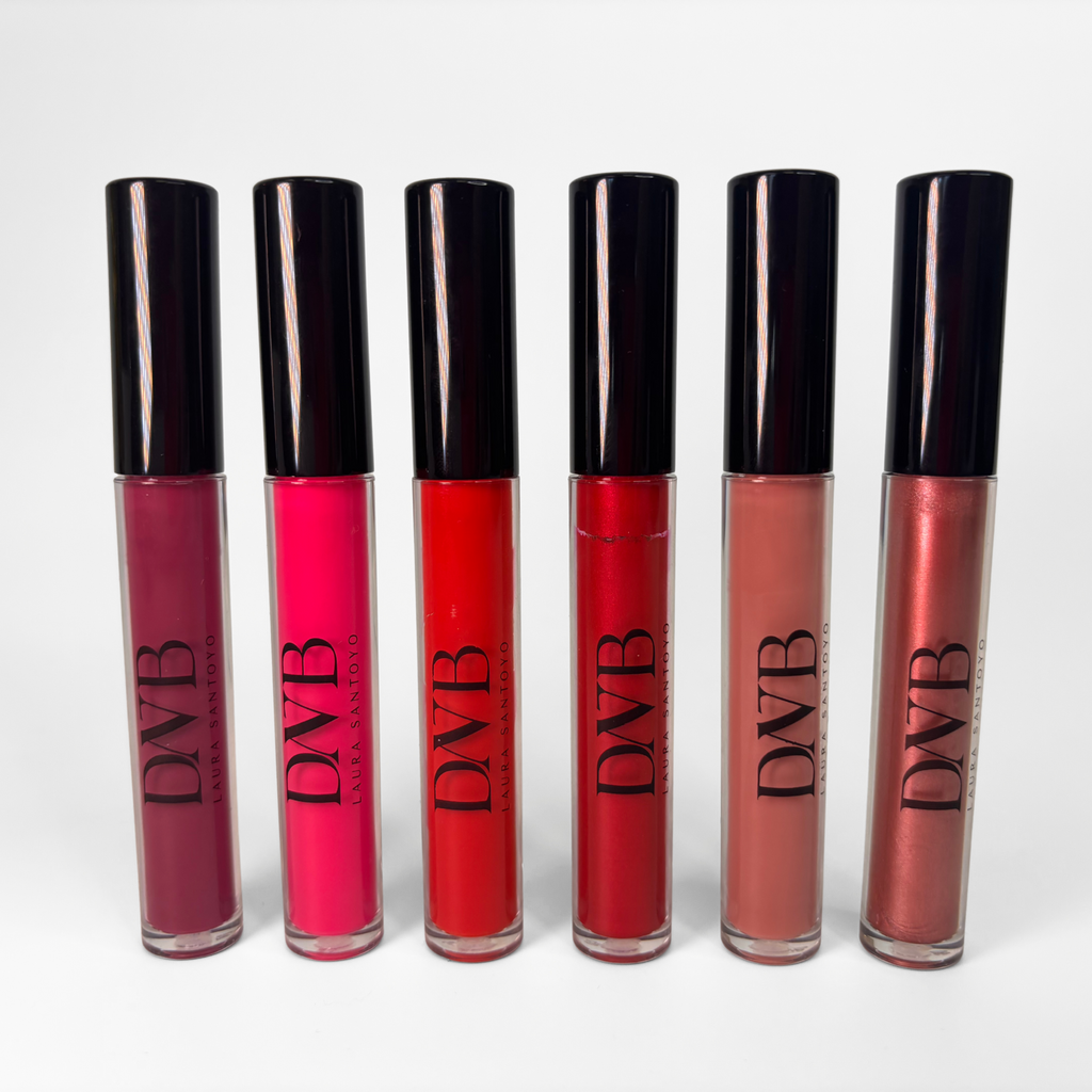 Set of six lip glosses with black caps on a white background