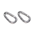 Two silver earrings on a textured white background