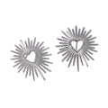 Silver sunburst earrings with heart centers on a white background